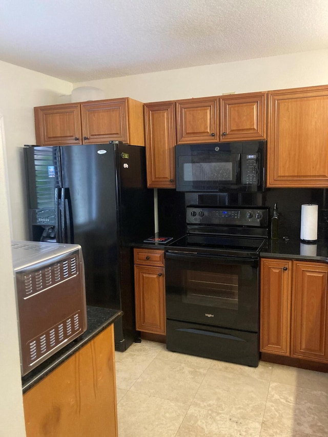 1401 Tidal Pointe Blvd Unit 102, Jupiter, FL 33477 - kitchen featuring black appliances, brown cabinetry, and light tile patterned flooring