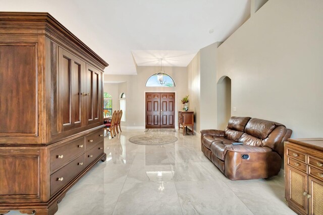 4610 Bucida Rd, Boynton Beach, FL 33436 - entryway with arched walkways, light marble finish flooring, and baseboards