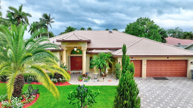 4610 Bucida Rd, Boynton Beach, FL 33436 - view of front of home featuring an attached garage, decorative driveway, a tile roof, and stucco siding