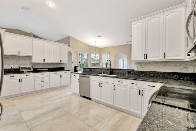 4610 Bucida Rd, Boynton Beach, FL 33436 - kitchen with appliances with stainless steel finishes, a sink, arched walkways, white cabinets, and lofted ceiling