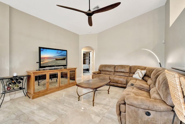 4610 Bucida Rd, Boynton Beach, FL 33436 - living room with arched walkways, a ceiling fan, and light marble finish floors