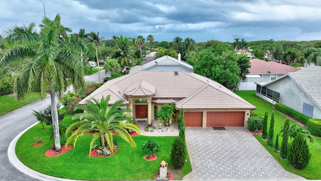 4610 Bucida Rd, Boynton Beach, FL 33436 - view of front of property featuring a garage, a tiled roof, decorative driveway, and stucco siding