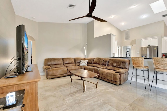 4610 Bucida Rd, Boynton Beach, FL 33436 - living room featuring ceiling fan, high vaulted ceiling, arched walkways, and a skylight