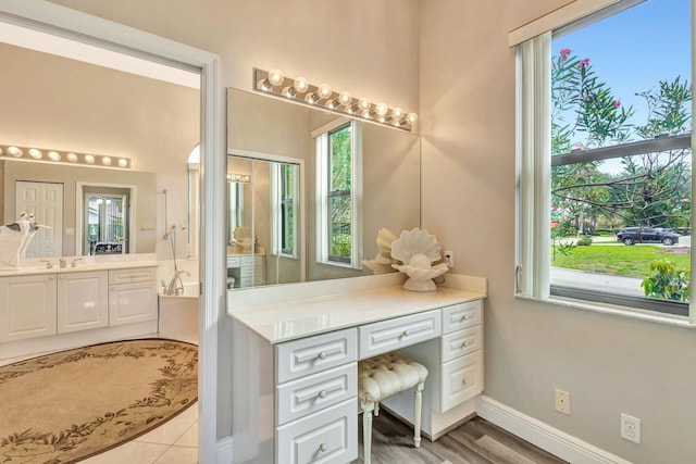 4610 Bucida Rd, Boynton Beach, FL 33436 - full bath with plenty of natural light, vanity, and baseboards