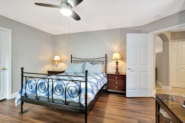 4610 Bucida Rd, Boynton Beach, FL 33436 - bedroom with arched walkways, wood finished floors, baseboards, and a ceiling fan