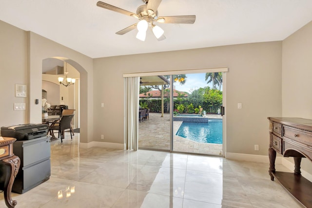 4610 Bucida Rd, Boynton Beach, FL 33436 - living room featuring arched walkways, a ceiling fan, baseboards, and light marble finish flooring