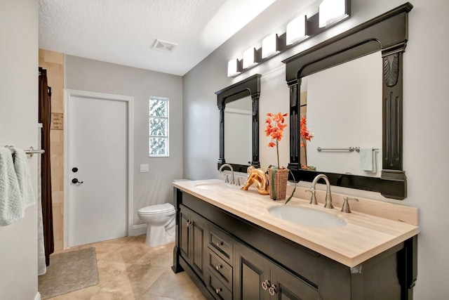 4610 Bucida Rd, Boynton Beach, FL 33436 - full bath with double vanity, toilet, and a textured ceiling