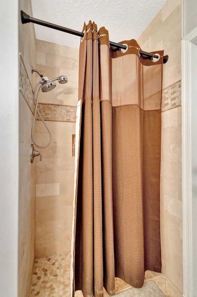 4610 Bucida Rd, Boynton Beach, FL 33436 - full bathroom featuring a stall shower and a textured ceiling