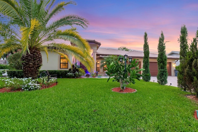 4610 Bucida Rd, Boynton Beach, FL 33436 - mediterranean / spanish-style home with an attached garage, a tiled roof, a front lawn, and stucco siding