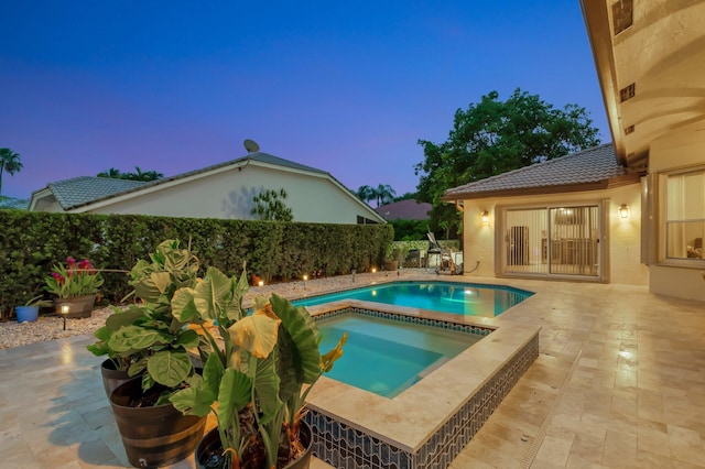 4610 Bucida Rd, Boynton Beach, FL 33436 - pool at dusk with a patio, an in-ground hot tub, and a fenced backyard