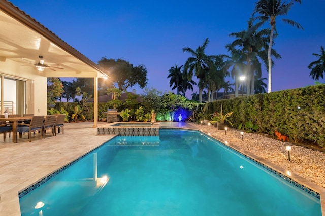 4610 Bucida Rd, Boynton Beach, FL 33436 - pool at twilight featuring a ceiling fan, a patio area, a fenced backyard, outdoor dining space, and a pool with connected hot tub