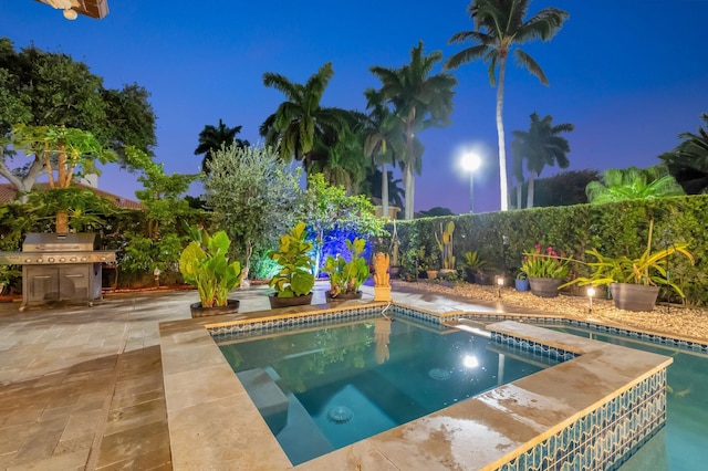 4610 Bucida Rd, Boynton Beach, FL 33436 - pool at twilight featuring an outdoor hot tub, a grill, and a patio area