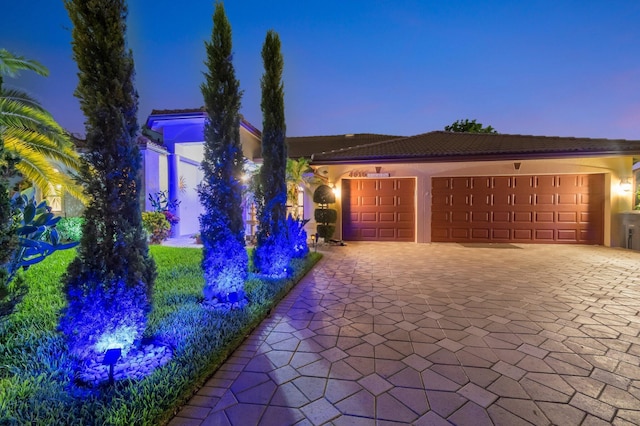 4610 Bucida Rd, Boynton Beach, FL 33436 - view of front facade with decorative driveway, a garage, stucco siding, and a tile roof