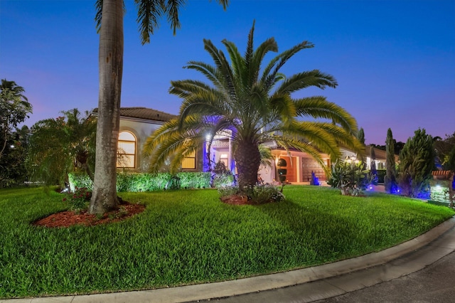 4610 Bucida Rd, Boynton Beach, FL 33436 - view of front of home with a lawn, a tile roof, and stucco siding