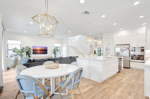 13291 Machiavelli Way, Palm Beach Gardens, FL 33418 - dining area with stairs, light wood-style flooring, recessed lighting, and a chandelier