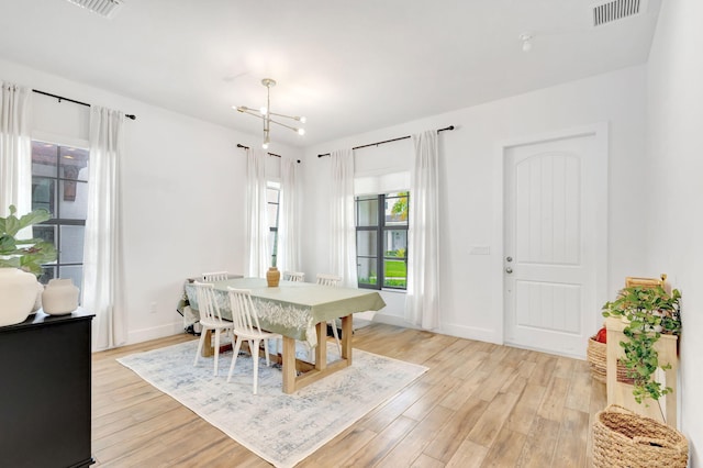 13291 Machiavelli Way, Palm Beach Gardens, FL 33418 - dining space featuring light wood-style flooring, a chandelier, and baseboards