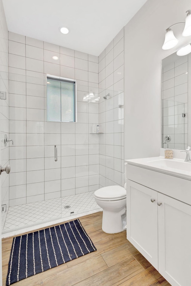 13291 Machiavelli Way, Palm Beach Gardens, FL 33418 - bathroom with wood finished floors, a shower stall, vanity, toilet, and recessed lighting