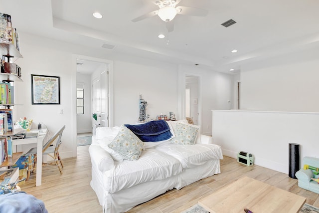 13291 Machiavelli Way, Palm Beach Gardens, FL 33418 - living area with a raised ceiling, a ceiling fan, recessed lighting, light wood-type flooring, and baseboards