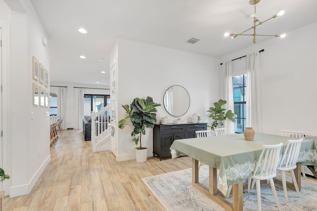 13291 Machiavelli Way, Palm Beach Gardens, FL 33418 - dining room with light wood-style flooring, healthy amount of natural light, a chandelier, and recessed lighting