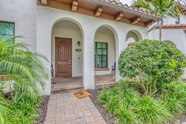 13291 Machiavelli Way, Palm Beach Gardens, FL 33418 - view of exterior entry with stucco siding and a porch