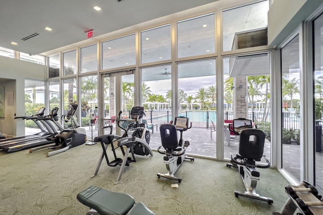 13291 Machiavelli Way, Palm Beach Gardens, FL 33418 - exercise room featuring carpet flooring, a wall of windows, a towering ceiling, and recessed lighting
