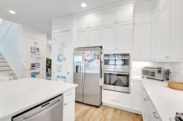 13291 Machiavelli Way, Palm Beach Gardens, FL 33418 - kitchen featuring stainless steel appliances, recessed lighting, light wood-type flooring, white cabinetry, and tasteful backsplash
