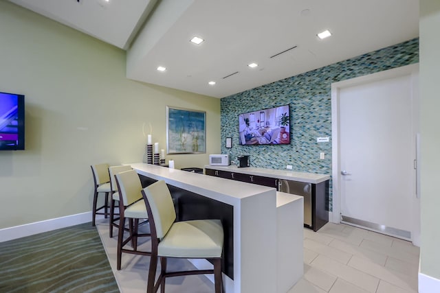 13291 Machiavelli Way, Palm Beach Gardens, FL 33418 - bar area featuring baseboards, recessed lighting, and white microwave