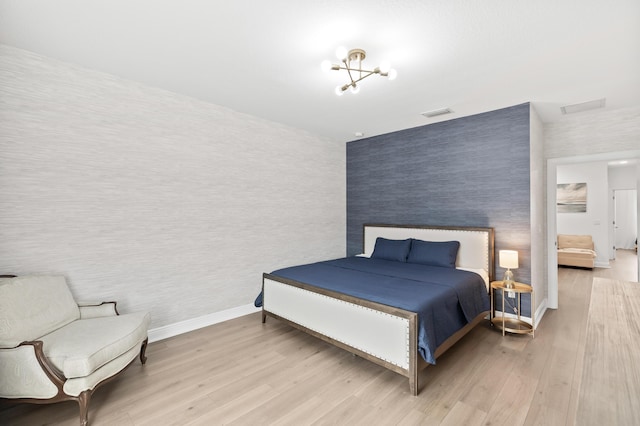 587 Sanderling Cir, Deerfield Beach, FL 33442 - bedroom with wallpapered walls, wood finished floors, baseboards, and an accent wall