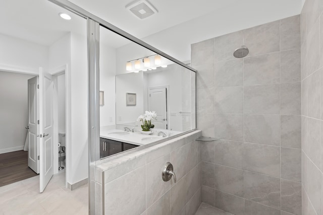587 Sanderling Cir, Deerfield Beach, FL 33442 - bathroom with a tile shower, double vanity, and baseboards