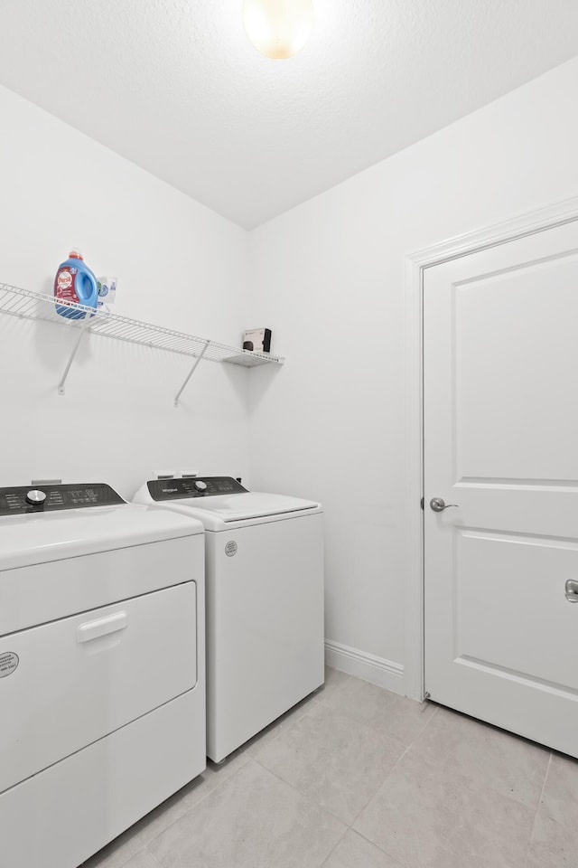 587 Sanderling Cir, Deerfield Beach, FL 33442 - washroom with independent washer and dryer, light tile patterned flooring, and baseboards