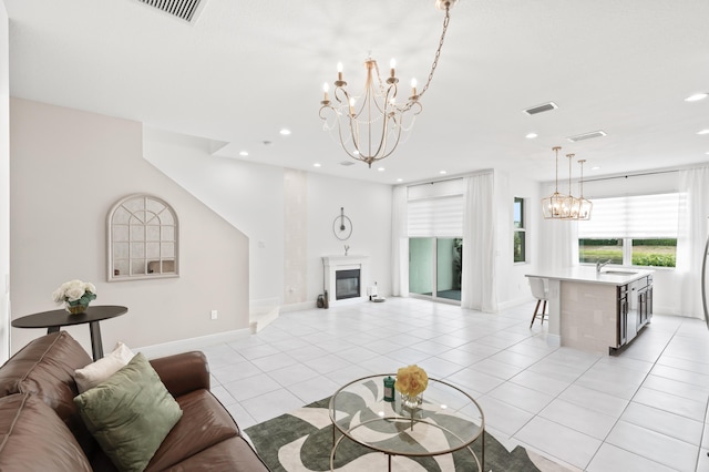 587 Sanderling Cir, Deerfield Beach, FL 33442 - living room featuring a chandelier, baseboards, a glass covered fireplace, recessed lighting, and light tile patterned floors