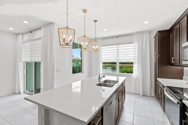587 Sanderling Cir, Deerfield Beach, FL 33442 - kitchen with a sink, appliances with stainless steel finishes, a chandelier, dark brown cabinetry, and light tile patterned flooring