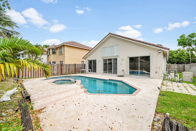 7591 NW 29th St, Margate, FL 33063 - view of swimming pool featuring an in-ground hot tub, a patio, and a fenced backyard