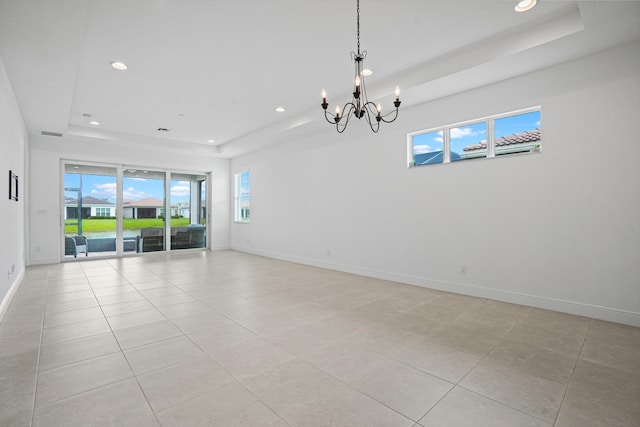 24038 SW Firenze Way, Port Saint Lucie, FL 34986 - empty room with a raised ceiling, a chandelier, recessed lighting, light tile patterned floors, and baseboards