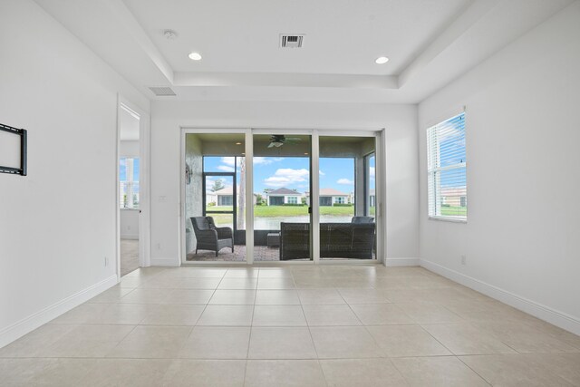 24038 SW Firenze Way, Port Saint Lucie, FL 34986 - empty room with a raised ceiling, light tile patterned floors, baseboards, and recessed lighting