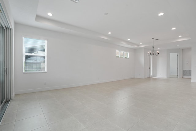 24038 SW Firenze Way, Port Saint Lucie, FL 34986 - spare room with a raised ceiling, a chandelier, recessed lighting, plenty of natural light, and light tile patterned floors