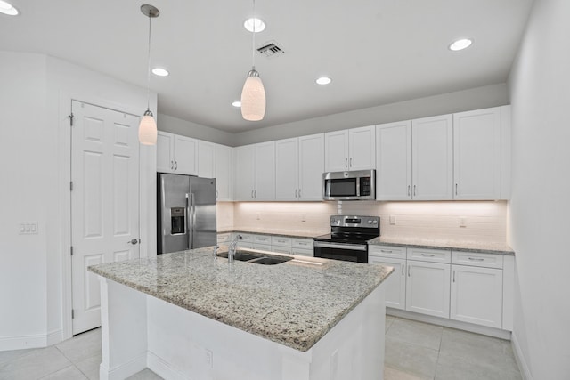 24038 SW Firenze Way, Port Saint Lucie, FL 34986 - kitchen featuring stainless steel appliances, a sink, light tile patterned floors, decorative backsplash, and white cabinets