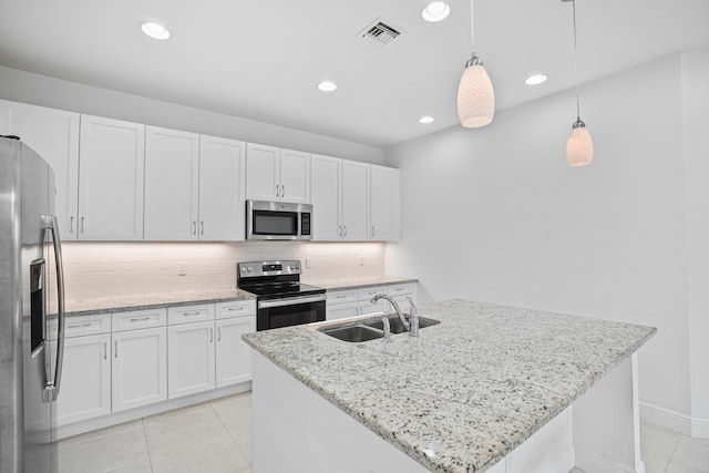 24038 SW Firenze Way, Port Saint Lucie, FL 34986 - kitchen featuring stainless steel appliances, a sink, light tile patterned floors, white cabinets, and recessed lighting