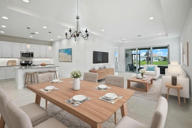 24038 SW Firenze Way, Port Saint Lucie, FL 34986 - dining room featuring recessed lighting, light tile patterned floors, and a chandelier