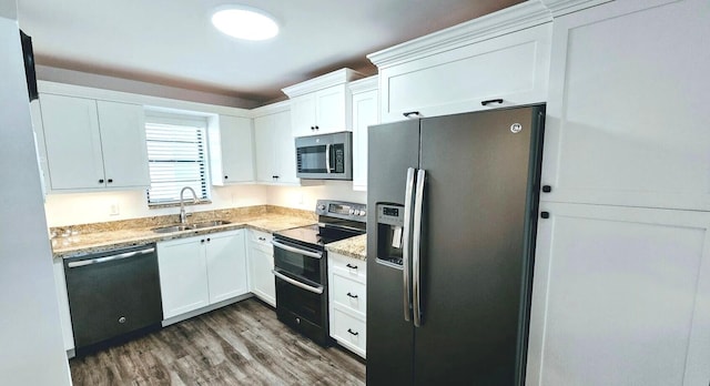 2430 Deer Creek Country Club Blvd Unit 205-2, Deerfield Beach, FL 33442 - kitchen with stainless steel appliances, dark wood-style flooring, white cabinetry, and light stone counters