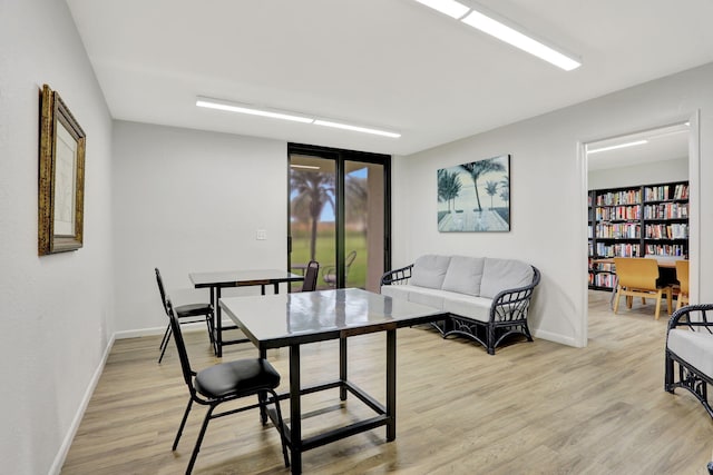 2430 Deer Creek Country Club Blvd Unit 205-2, Deerfield Beach, FL 33442 - dining room with light wood-style floors and baseboards