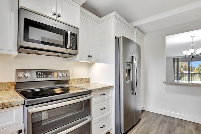 2430 Deer Creek Country Club Blvd Unit 205-2, Deerfield Beach, FL 33442 - kitchen featuring stainless steel appliances, light wood-style floors, white cabinets, a chandelier, and light stone countertops
