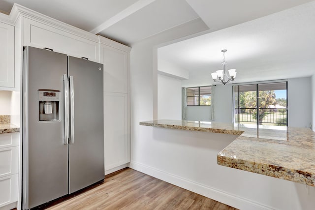 2430 Deer Creek Country Club Blvd Unit 205-2, Deerfield Beach, FL 33442 - kitchen with stainless steel fridge, a chandelier, light wood-style floors, white cabinets, and light stone countertops