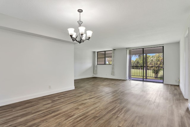 2430 Deer Creek Country Club Blvd Unit 205-2, Deerfield Beach, FL 33442 - unfurnished room with a chandelier and wood finished floors