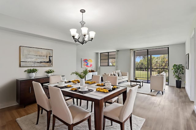 2430 Deer Creek Country Club Blvd Unit 205-2, Deerfield Beach, FL 33442 - dining area with a chandelier and light wood finished floors