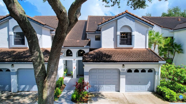 5419 Firenze Dr Unit K, Boynton Beach, FL 33437 - mediterranean / spanish-style house featuring a tiled roof, concrete driveway, stucco siding, and a garage