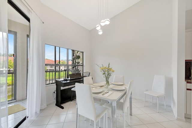 5419 Firenze Dr Unit K, Boynton Beach, FL 33437 - dining room featuring high vaulted ceiling, light tile patterned flooring, baseboards, and a chandelier