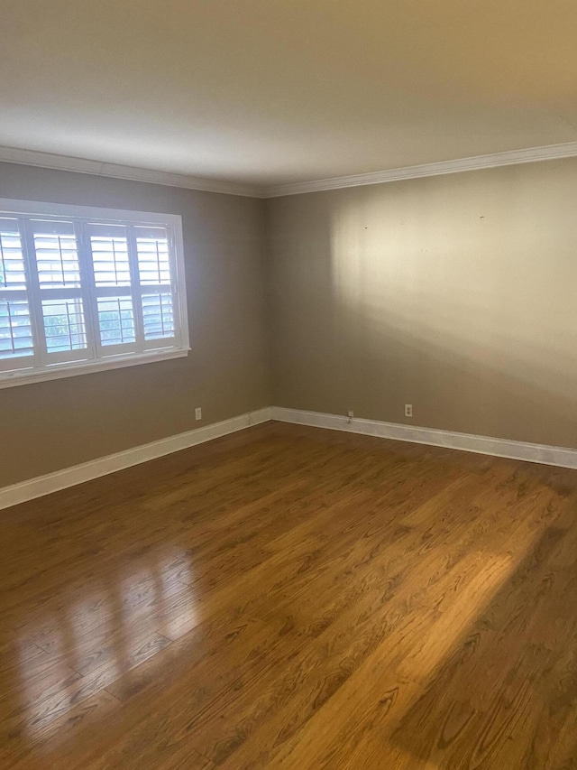 294 Brittany Unit G, Delray Beach, FL 33446 - empty room featuring ornamental molding, dark wood-style flooring, and baseboards