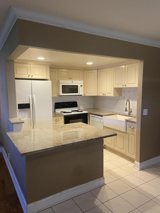 294 Brittany Unit G, Delray Beach, FL 33446 - kitchen featuring white appliances, a sink, crown molding, light stone countertops, and white cabinets