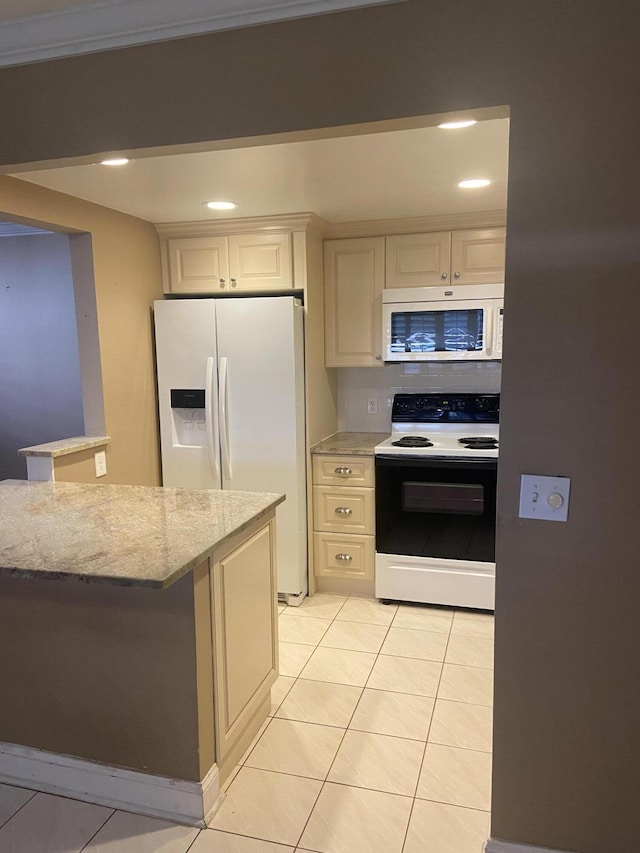 294 Brittany Unit G, Delray Beach, FL 33446 - kitchen featuring white appliances, recessed lighting, light stone countertops, light tile patterned floors, and white cabinets